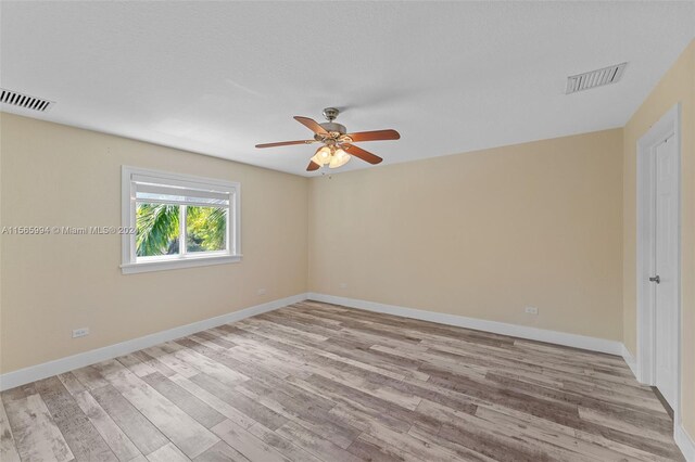 unfurnished room featuring ceiling fan and light hardwood / wood-style floors