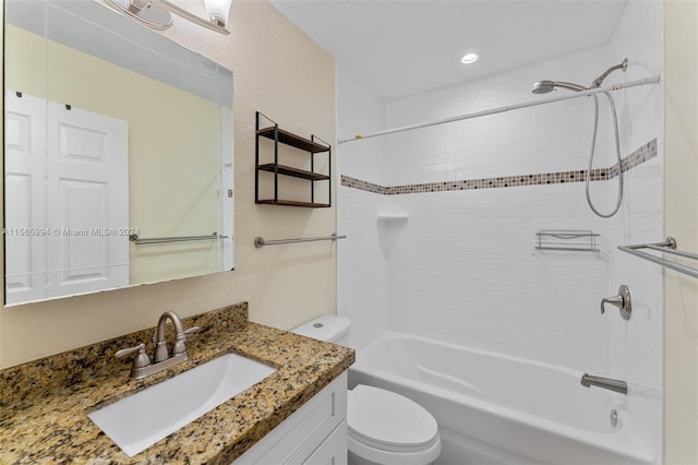 full bathroom featuring vanity, toilet, and tiled shower / bath