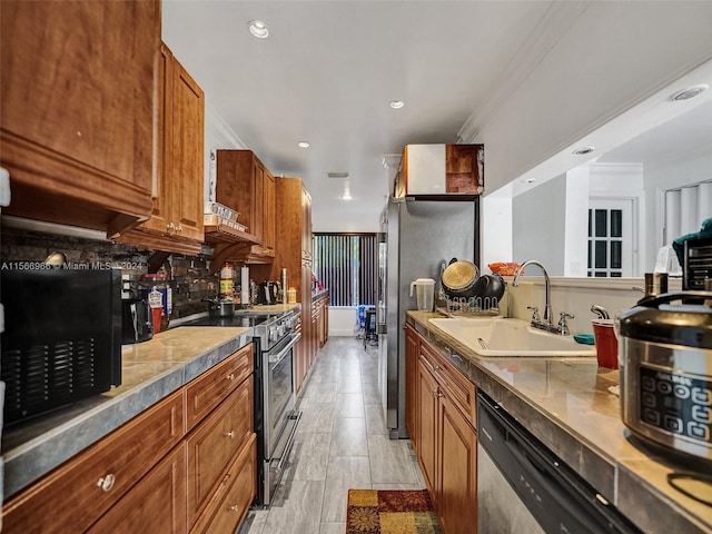 kitchen featuring backsplash, stainless steel appliances, crown molding, sink, and light tile floors