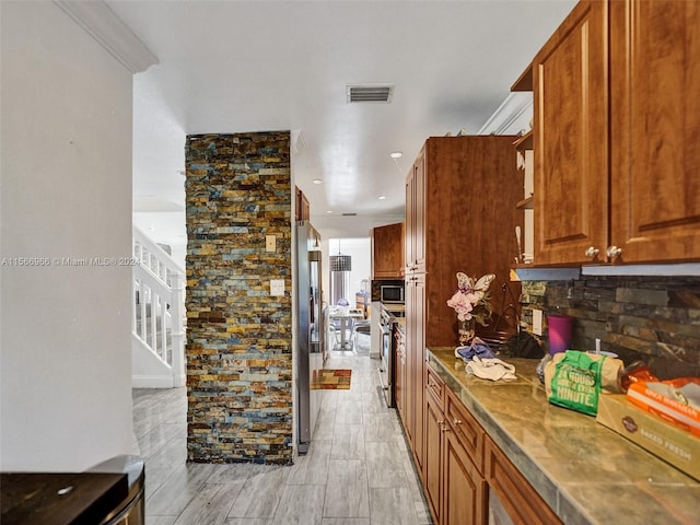 kitchen with backsplash and appliances with stainless steel finishes