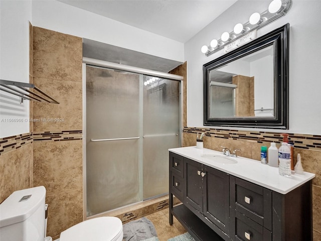 bathroom with walk in shower, vanity, tile walls, tile flooring, and toilet