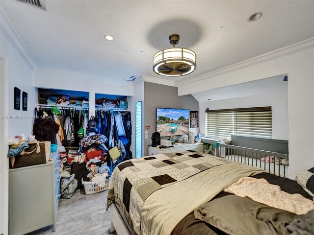 bedroom featuring multiple windows and crown molding