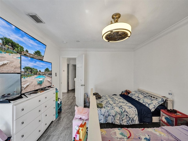 bedroom featuring hardwood / wood-style flooring and crown molding