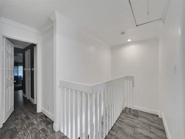 hall with ornamental molding and dark tile floors