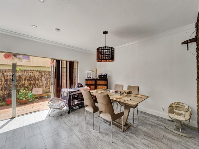 dining space featuring a healthy amount of sunlight and crown molding