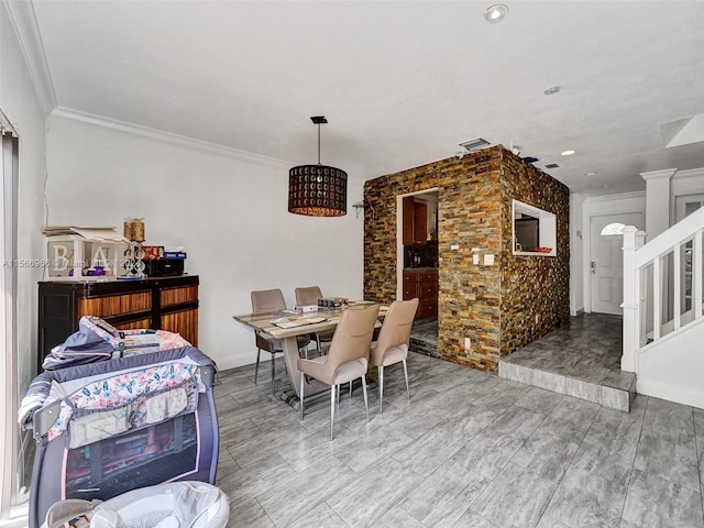 dining space with crown molding