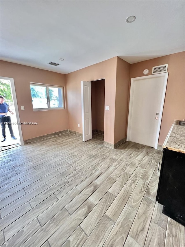 unfurnished living room featuring light hardwood / wood-style floors