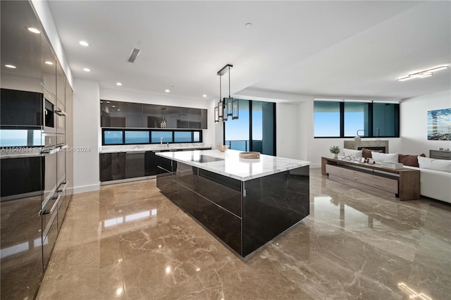 kitchen with a kitchen island, pendant lighting, and light stone counters