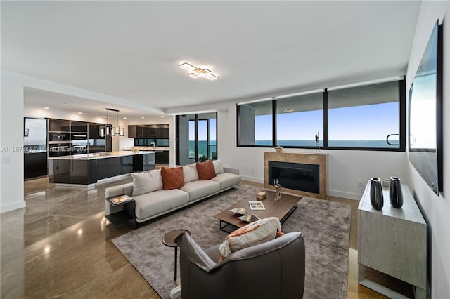 tiled living room featuring a water view