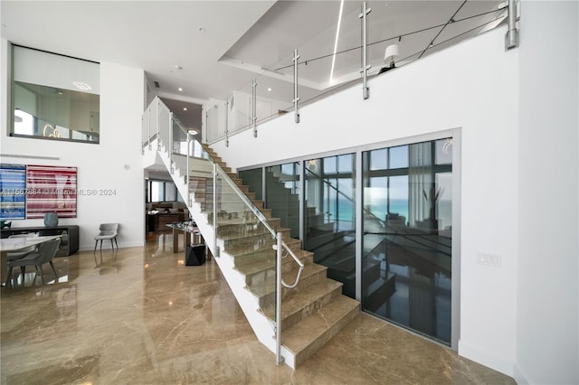 staircase featuring a high ceiling