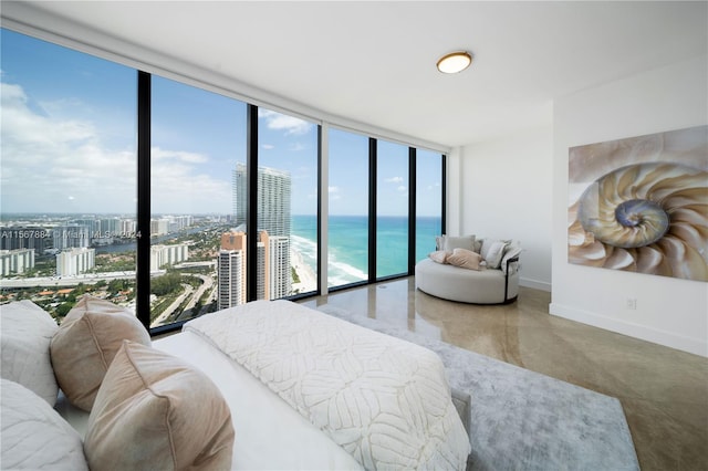 bedroom featuring a water view, expansive windows, access to exterior, and multiple windows