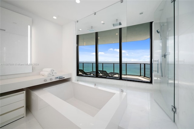 bathroom with a water view, tile flooring, and plus walk in shower