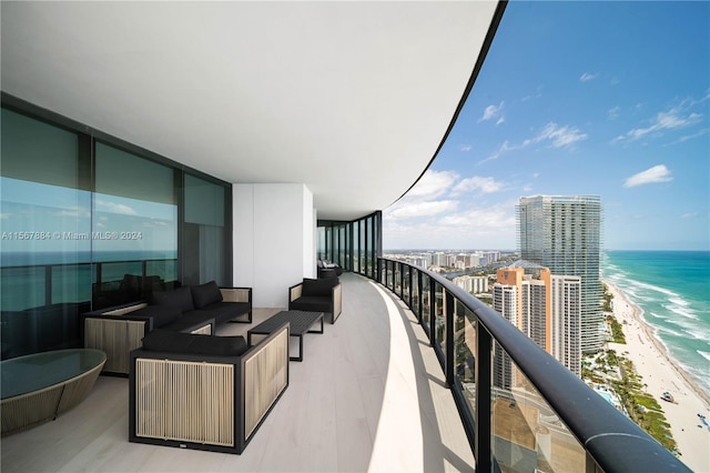 balcony with a water view, a view of the beach, and an outdoor hangout area