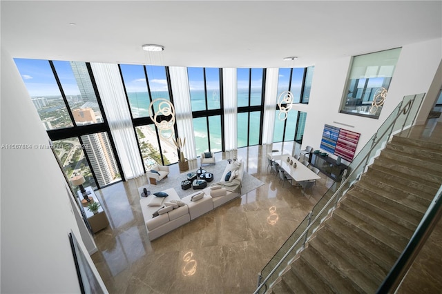 living room featuring expansive windows and a high ceiling