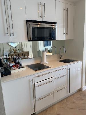 kitchen with white cabinets, sink, and black electric cooktop