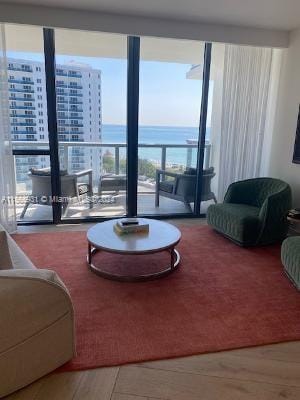 living room with a wall of windows and a water view