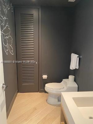 bathroom featuring vanity, toilet, and hardwood / wood-style flooring