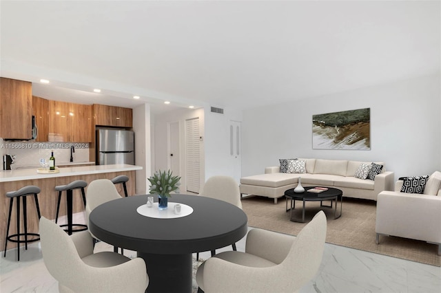 dining space with light tile floors