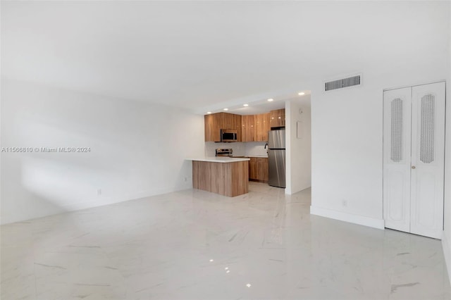 unfurnished living room with light tile flooring