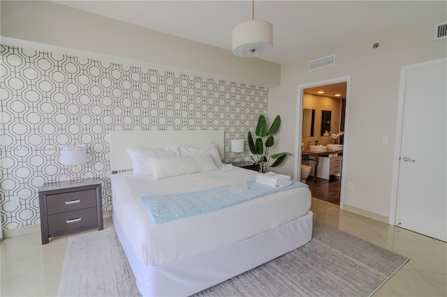 tiled bedroom featuring connected bathroom