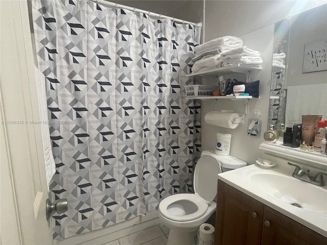 bathroom with tile floors, vanity, and toilet