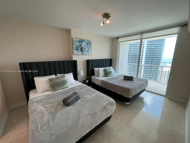 bedroom featuring floor to ceiling windows, a textured ceiling, access to outside, and light tile floors