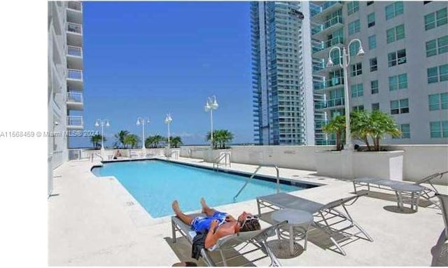 view of swimming pool featuring a patio