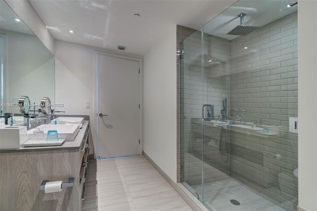 4010 S Ocean Dr Unit R3308, Hollywood, FL 33019 - bathroom featuring visible vents, a sink, a stall shower, double vanity, and baseboards