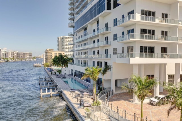 view of property featuring a water view and a community pool