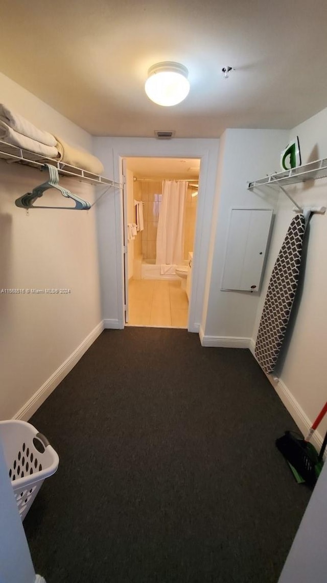 walk in closet featuring tile flooring