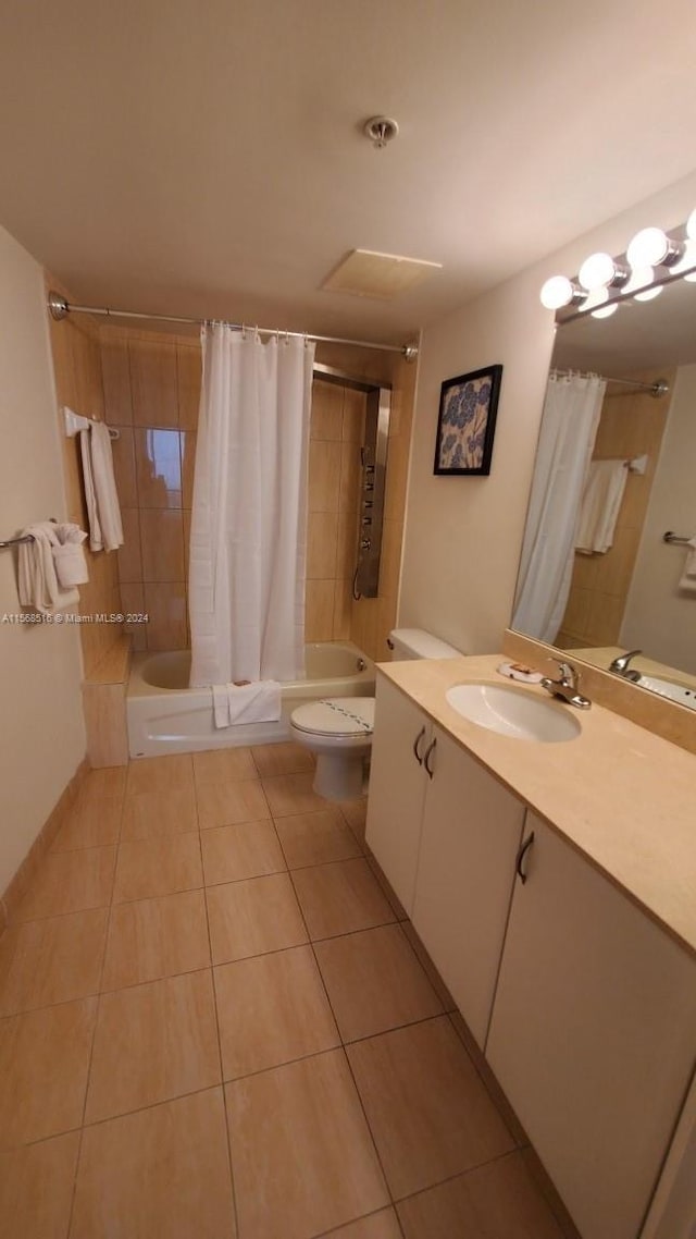 full bathroom with large vanity, shower / bath combination with curtain, toilet, and tile flooring