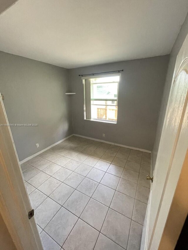 empty room with light tile patterned flooring