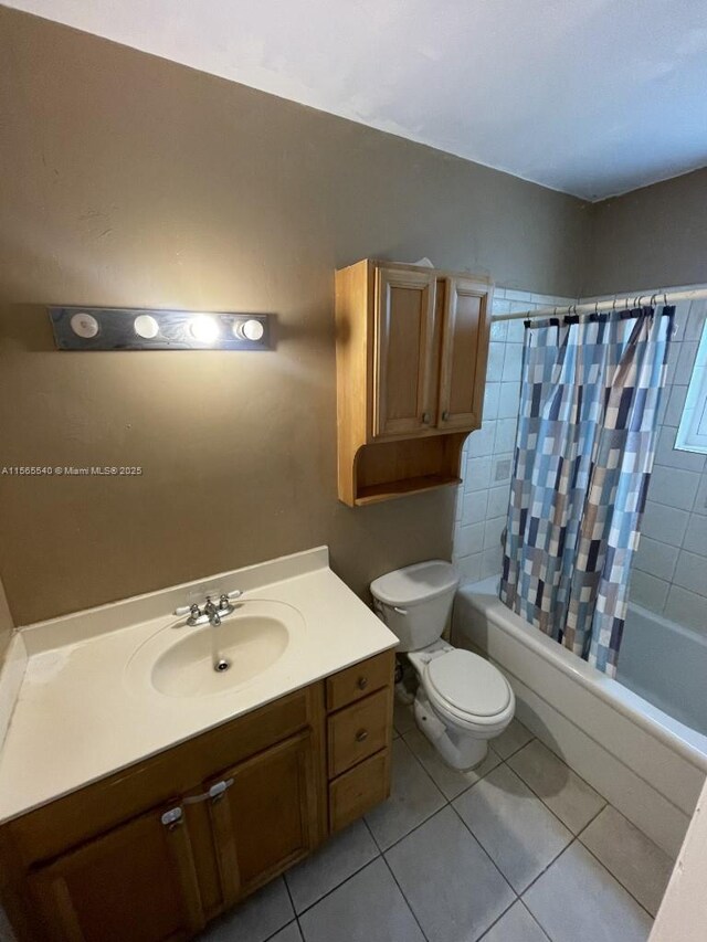 full bathroom with shower / tub combo, vanity, tile patterned flooring, and toilet