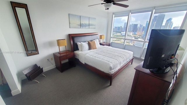 bedroom with ceiling fan and dark colored carpet