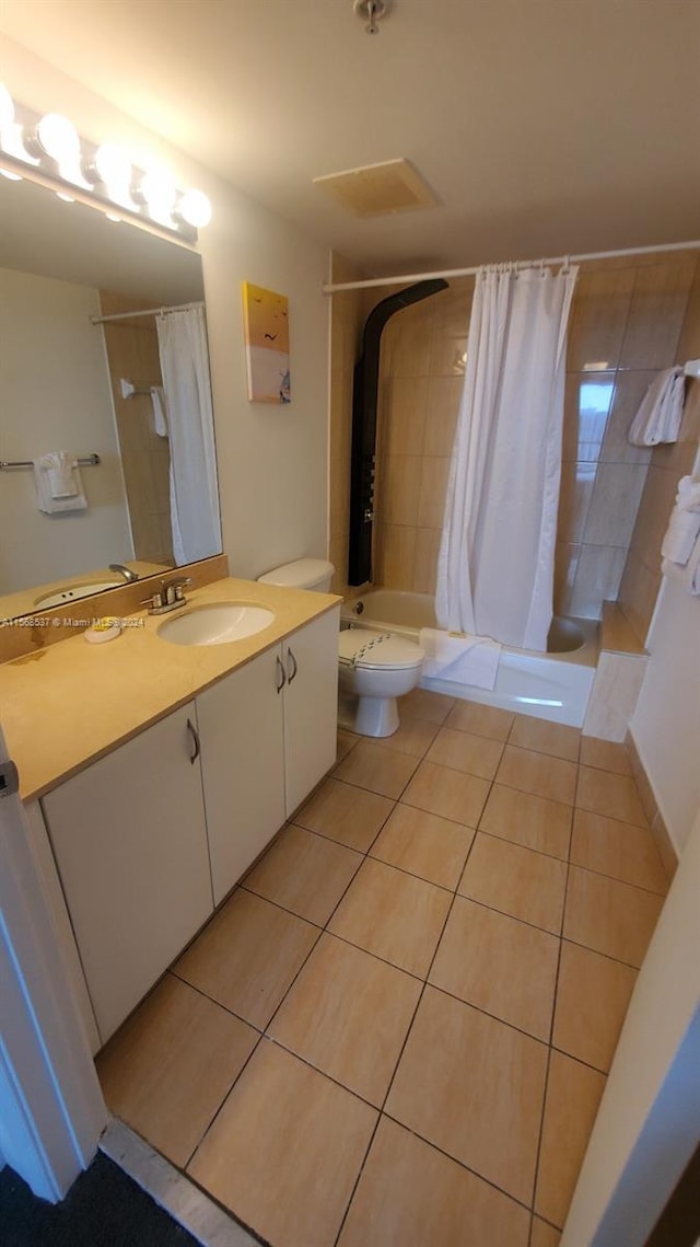 full bathroom with vanity, shower / tub combo, toilet, and tile flooring