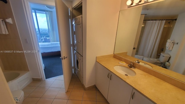 full bathroom featuring toilet, shower / tub combo with curtain, vanity, stacked washing maching and dryer, and tile floors