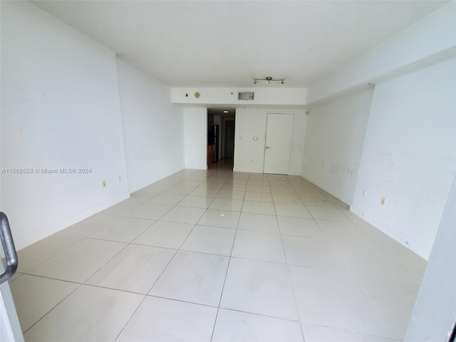 unfurnished room with light tile floors