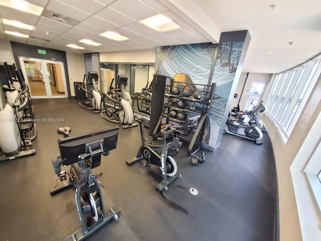 workout area with a paneled ceiling