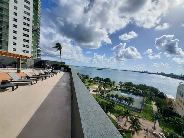 exterior space featuring a water view and a pergola