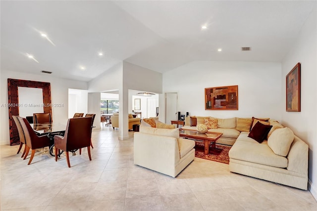 living room featuring light tile floors and vaulted ceiling