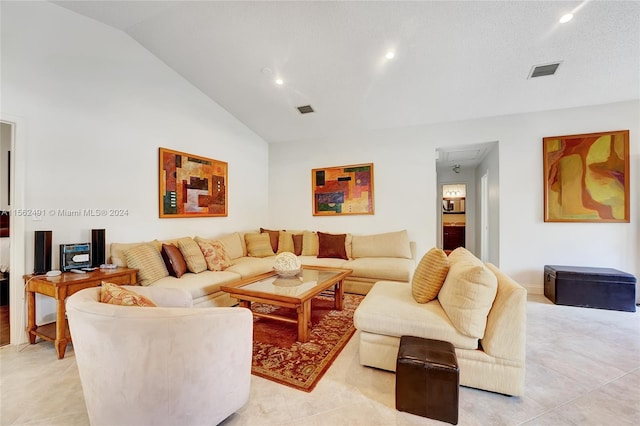 tiled living room featuring high vaulted ceiling