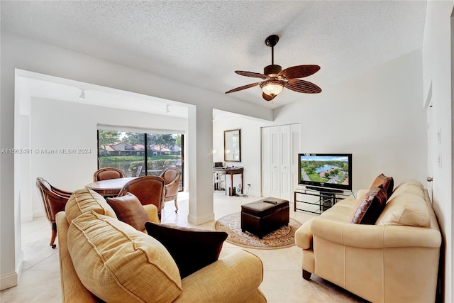 tiled living room with ceiling fan and a textured ceiling