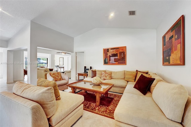 living room with tile floors, high vaulted ceiling, ceiling fan, and a textured ceiling