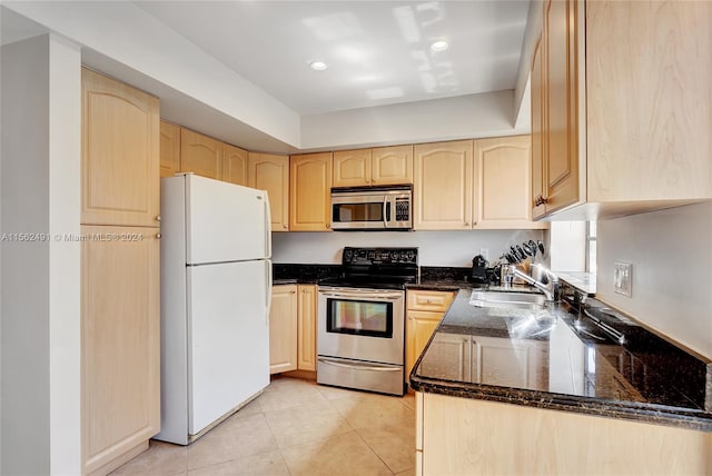 kitchen with stainless steel appliances, light brown cabinetry, sink, and light tile floors