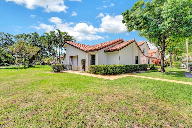 view of side of home with a yard