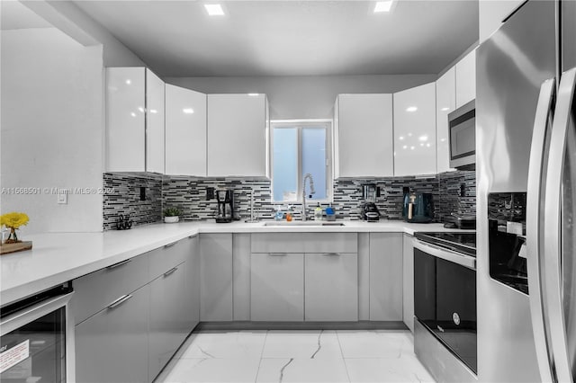 kitchen featuring white cabinets, wine cooler, appliances with stainless steel finishes, and light tile floors