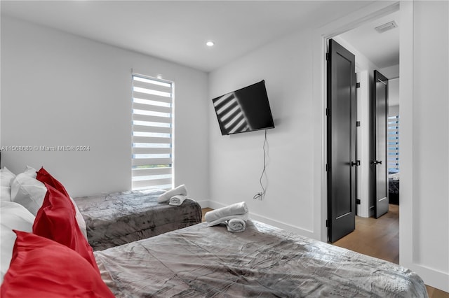 bedroom with wood-type flooring