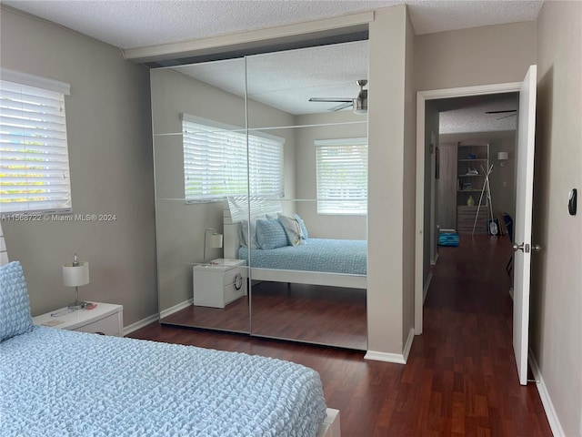 bedroom featuring a closet, ceiling fan, dark hardwood / wood-style flooring, and a textured ceiling