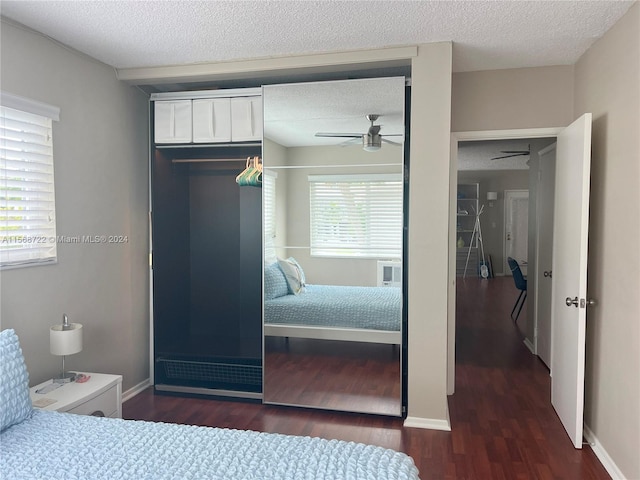 bedroom with dark hardwood / wood-style flooring, multiple windows, and ceiling fan