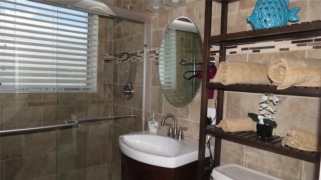 bathroom featuring tile walls, backsplash, toilet, and vanity